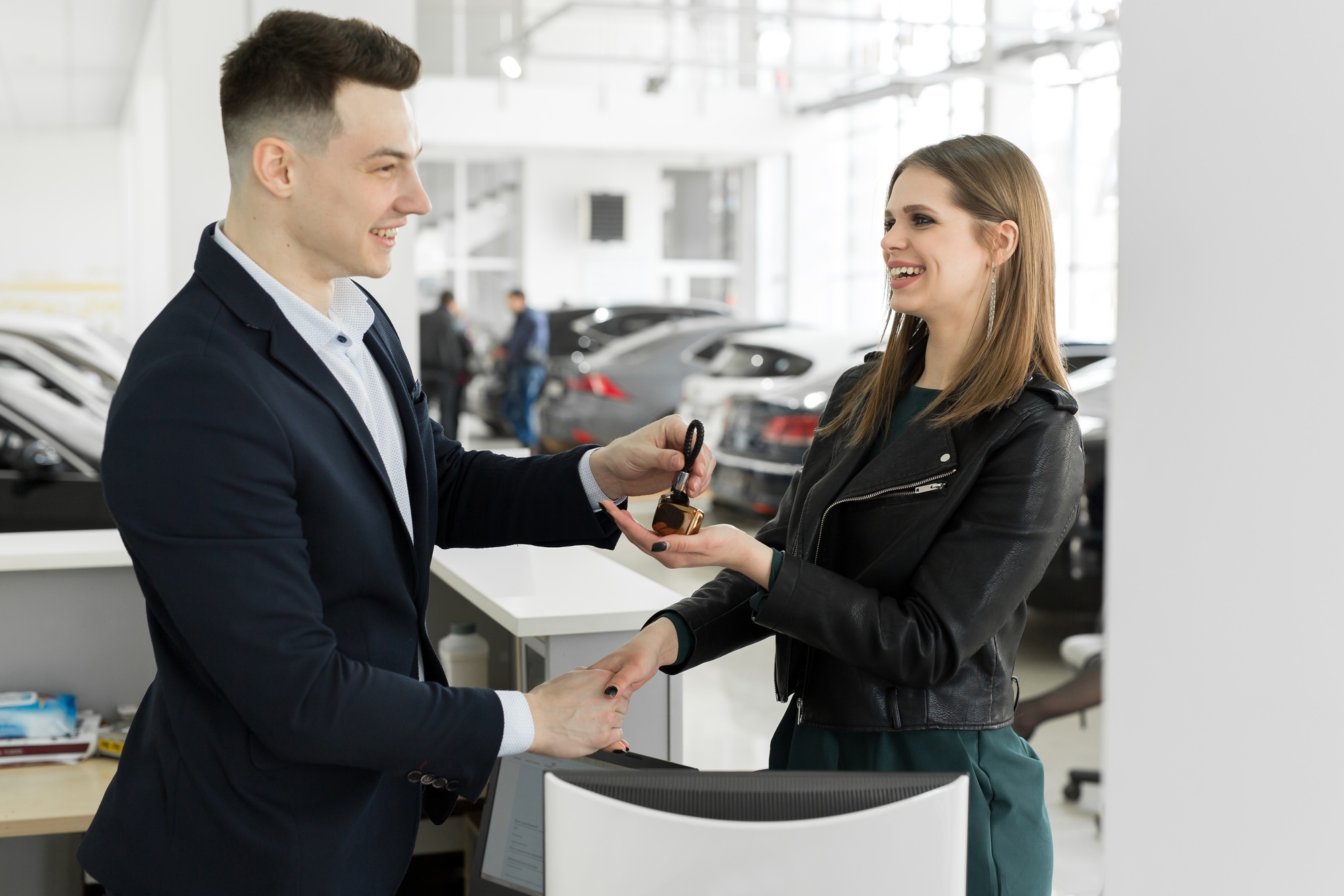 Car rental and Insurance concept, Young salesman receiving money and giving car's key to